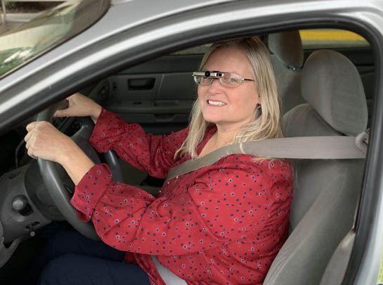 Woman driving while wearing a bioptic telescopic lense