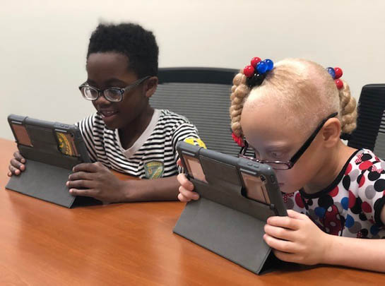 Two students learning to use iPads