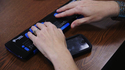 Picture of Hands using a braille machine